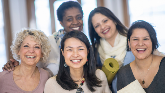 This photograph features a group of multiracial women standing together representing unity. 